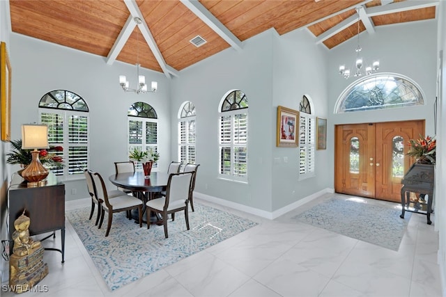 entrance foyer featuring wooden ceiling, high vaulted ceiling, beam ceiling, and a notable chandelier