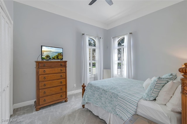 bedroom with light colored carpet and ceiling fan