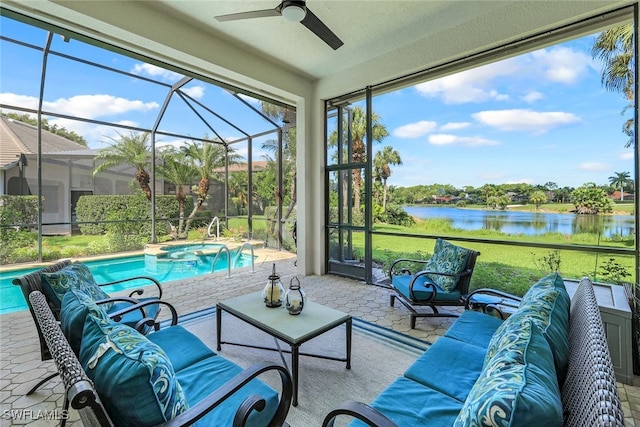 sunroom featuring ceiling fan and a water view