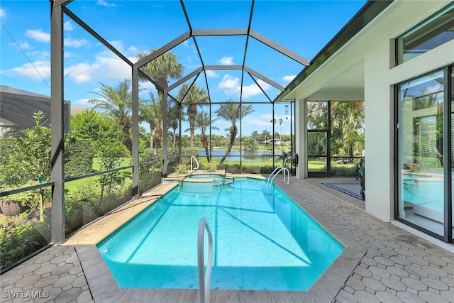 view of swimming pool featuring a patio, glass enclosure, and an in ground hot tub