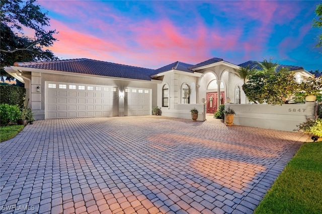 mediterranean / spanish house with a garage