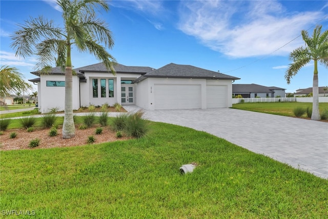 view of front of home featuring a garage and a front lawn