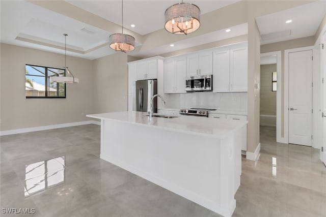 kitchen with sink, a kitchen island with sink, stainless steel appliances, and white cabinets