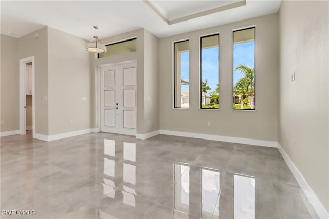 spare room with a raised ceiling