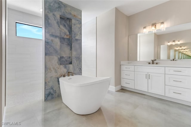 bathroom with tile walls, vanity, and a bathtub