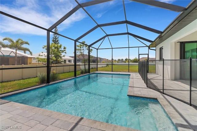 view of swimming pool featuring a lanai and a yard