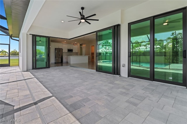 view of patio featuring a lanai and ceiling fan