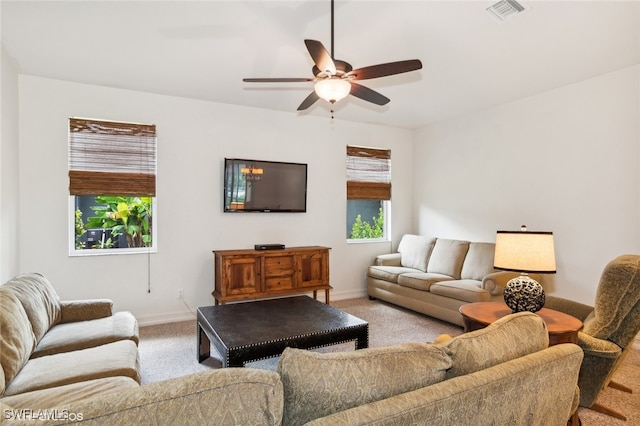 carpeted living room featuring ceiling fan