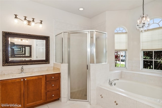 bathroom with plus walk in shower, vanity, an inviting chandelier, and a healthy amount of sunlight