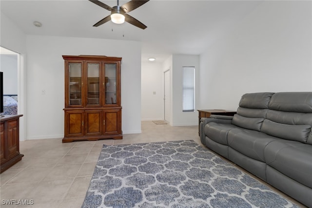 tiled living room with ceiling fan