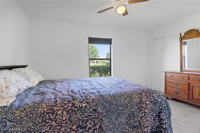 bedroom with ceiling fan and light tile patterned floors