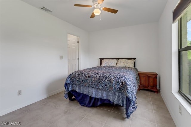 tiled bedroom with ceiling fan