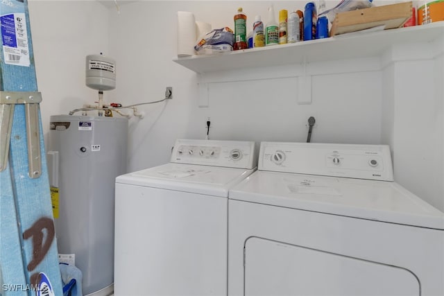 laundry room with independent washer and dryer and water heater