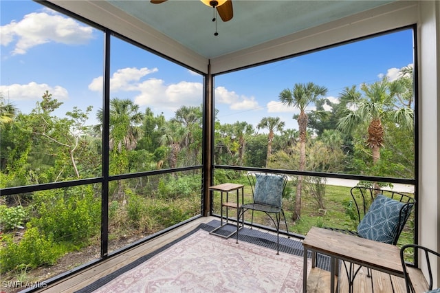 unfurnished sunroom featuring a ceiling fan