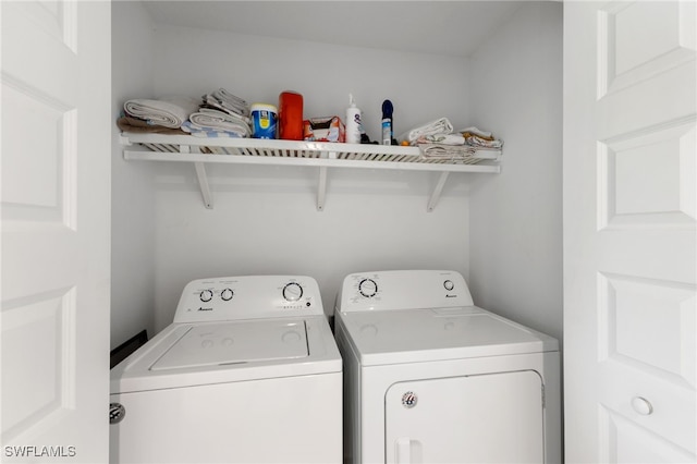 washroom with separate washer and dryer and laundry area