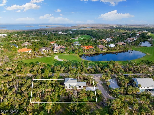 aerial view with golf course view and a water view