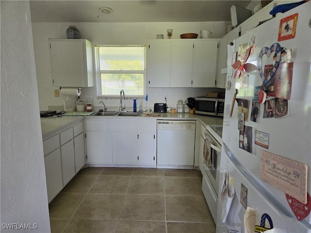 kitchen featuring sink, light tile patterned floors, white appliances, and white cabinetry