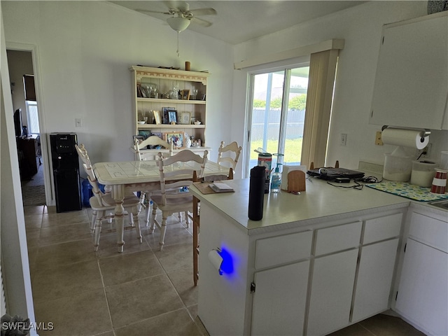 kitchen with white cabinets, ceiling fan, and light tile patterned floors