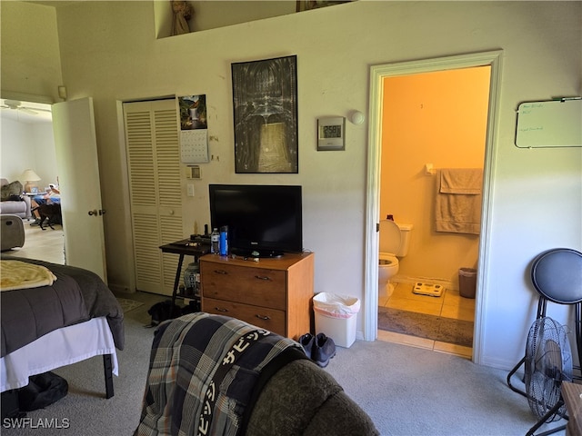 bedroom featuring a closet, carpet floors, and ensuite bathroom