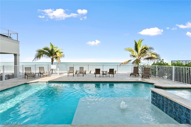 view of pool featuring pool water feature and a patio