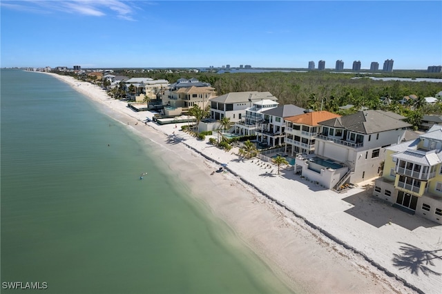 aerial view with a water view and a beach view