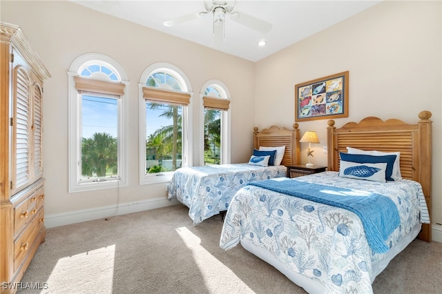 carpeted bedroom with ceiling fan and multiple windows