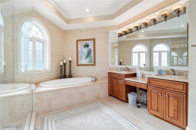 full bath with double vanity, a garden tub, a sink, and tile patterned floors