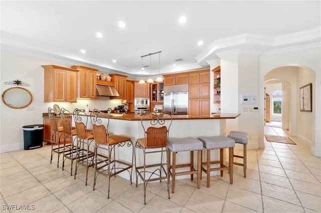 kitchen with built in appliances, a peninsula, open shelves, dark countertops, and decorative light fixtures