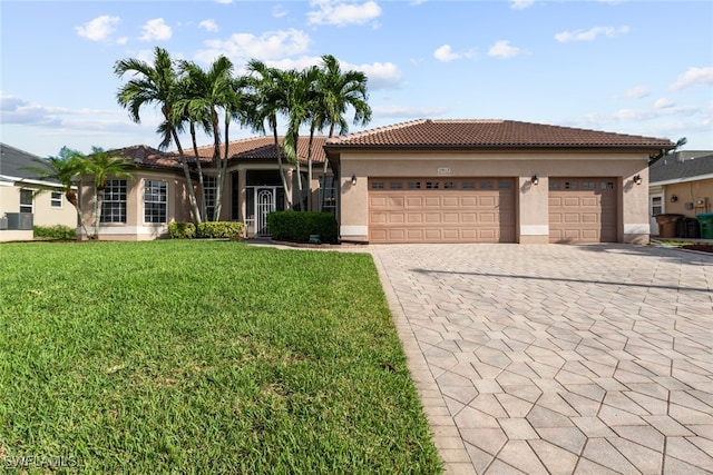 view of front of home featuring a garage and a front lawn