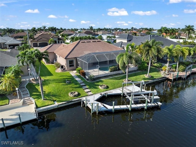 view of dock with a pool, a water view, a yard, and glass enclosure