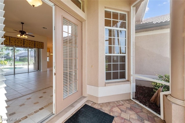 doorway to property featuring a patio area and ceiling fan