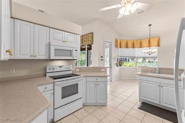 kitchen featuring light tile patterned floors, white cabinets, and white appliances