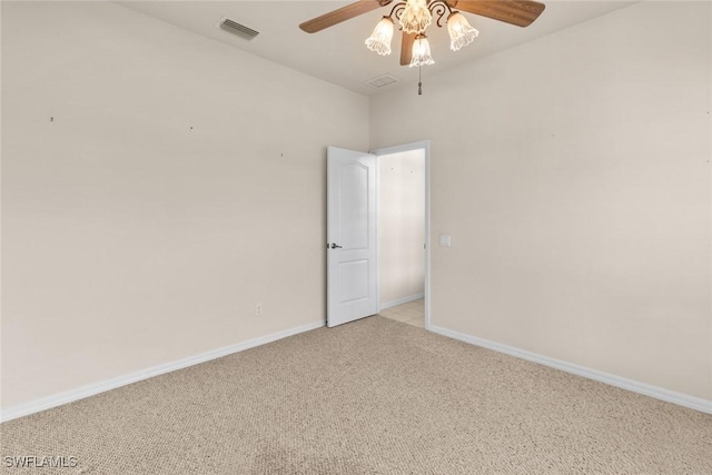 empty room featuring ceiling fan and light carpet