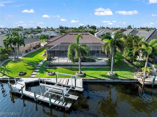 exterior space featuring a yard, a water view, and glass enclosure