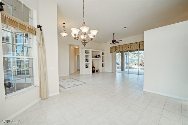 empty room featuring ceiling fan with notable chandelier