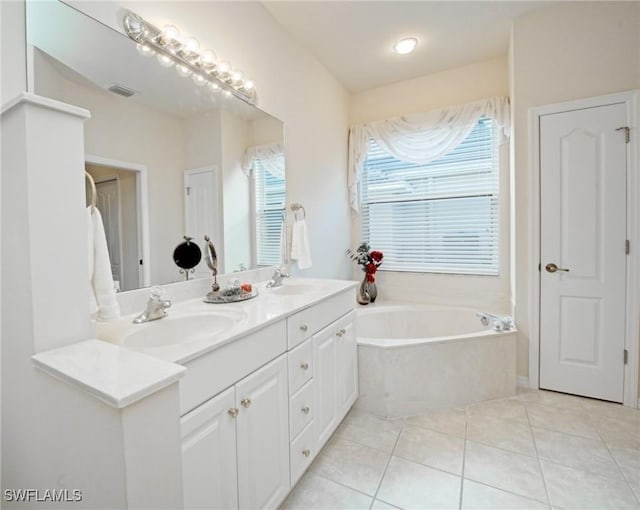 bathroom with vanity, tile patterned floors, and a bathing tub