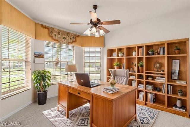 carpeted office space with ceiling fan