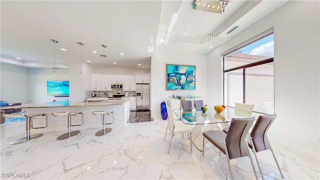 tiled dining area featuring sink