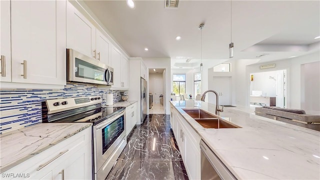 kitchen with a sink, visible vents, white cabinets, marble finish floor, and appliances with stainless steel finishes