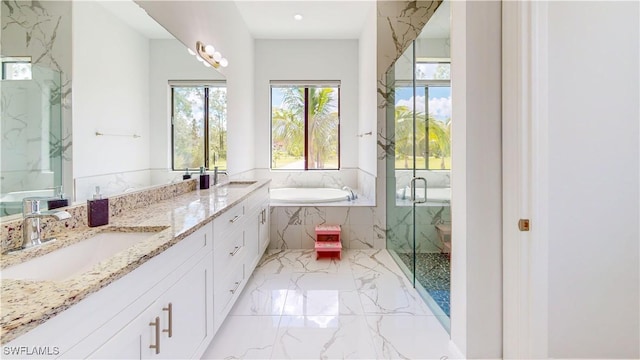 full bathroom with marble finish floor, a marble finish shower, double vanity, a sink, and a bath