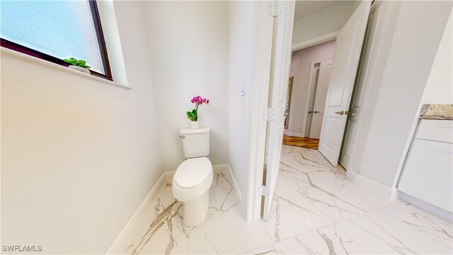 bathroom featuring vanity, toilet, and tile patterned floors