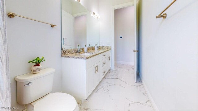 bathroom with vanity, toilet, and tile patterned floors