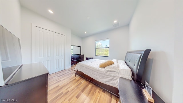 bedroom with a closet and light hardwood / wood-style flooring