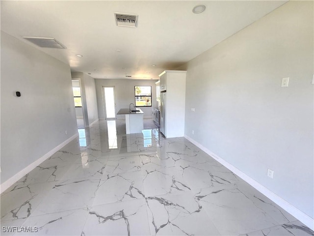 interior space featuring marble finish floor, visible vents, and baseboards