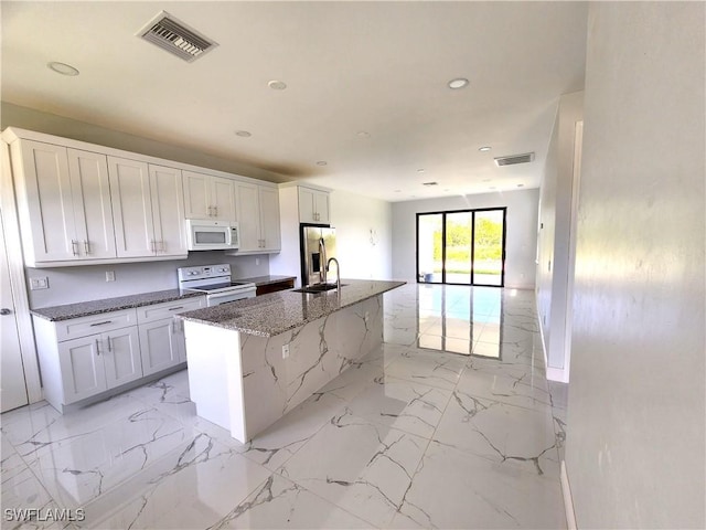 kitchen featuring white appliances, visible vents, a sink, and marble finish floor