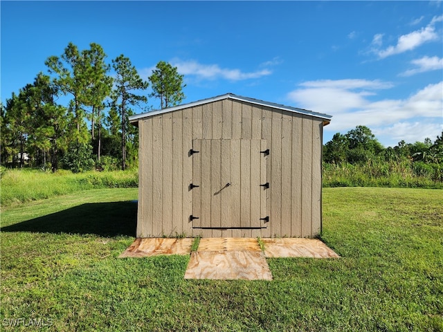 view of outdoor structure with a lawn