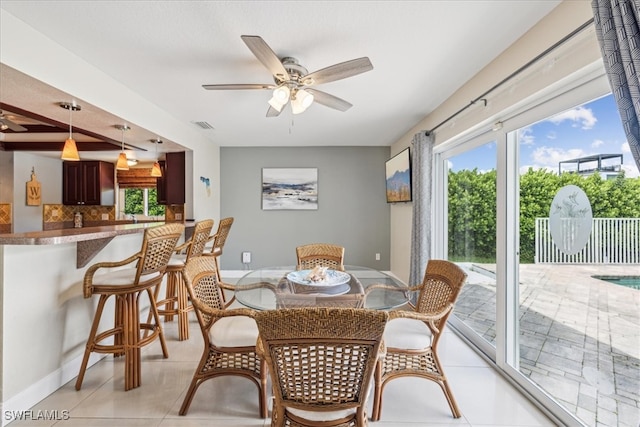 tiled dining room with ceiling fan