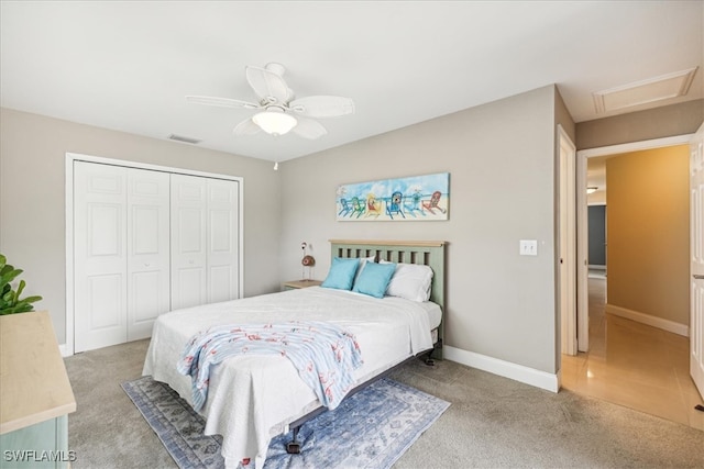 bedroom featuring light colored carpet, a closet, and ceiling fan