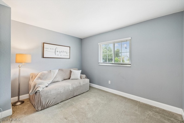 living area featuring light carpet