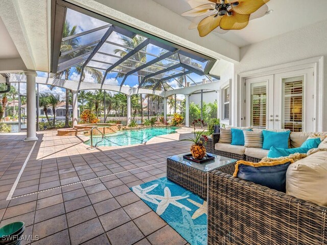 view of swimming pool with a lanai, an outdoor hangout area, a patio, and french doors